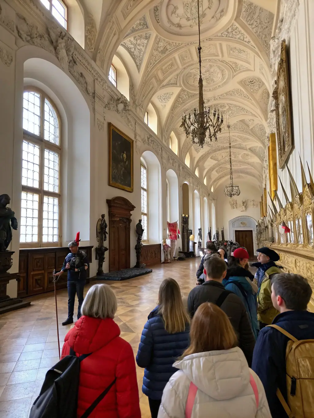 A photo of a guided tour group listening attentively to a historian explaining the history of the Chateau de Dame Hautebrune, emphasizing the foundation's educational outreach.